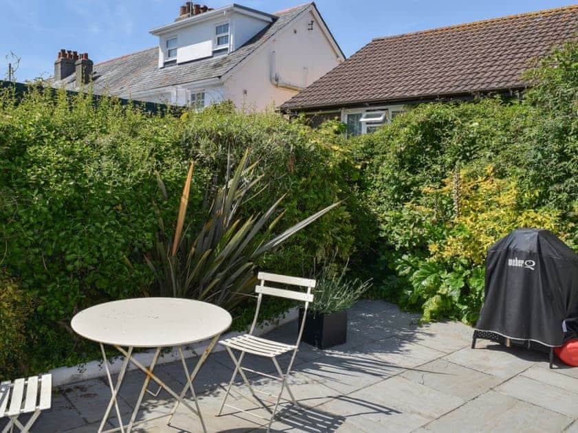 Delightful paved patio area with seating and barbecue | Weald, Salcombe
