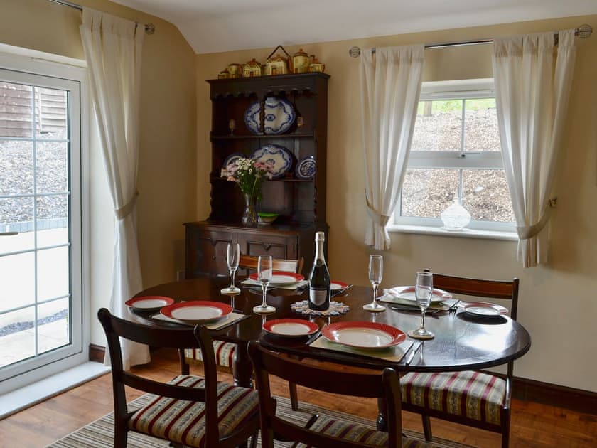 Dining room with French doors leading to garden | Dolfran Bach, Dolwen, near Betws-yn-Rhos, Abergele