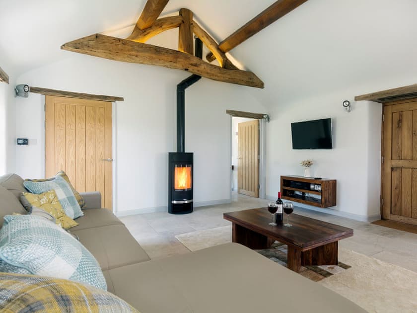Thoughtfully renovated living room area with wood burner | Puddledock Piggery, Berkley, near Frome