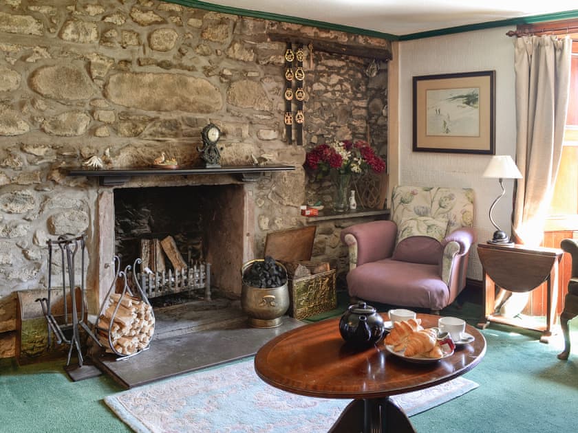 Characterful living room with an open fire | Dalvanie Mill, Folda, Glenisla