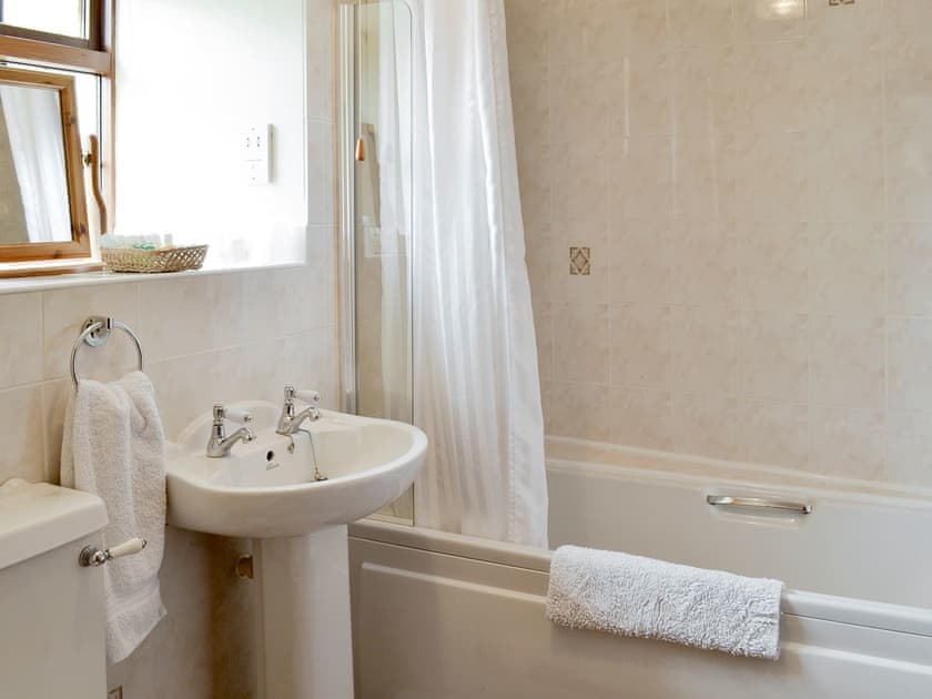 Family bathroom with shower over bath | Cow Pasture Cottage - Studley House Farm Cottages, Ebberston, near Scarborough