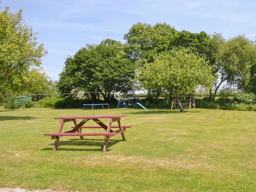 Large lawned garden with children’s play area  | Warren Cottage - Stowford Lodge Holiday Cottages, Langtree, near Great Torrington