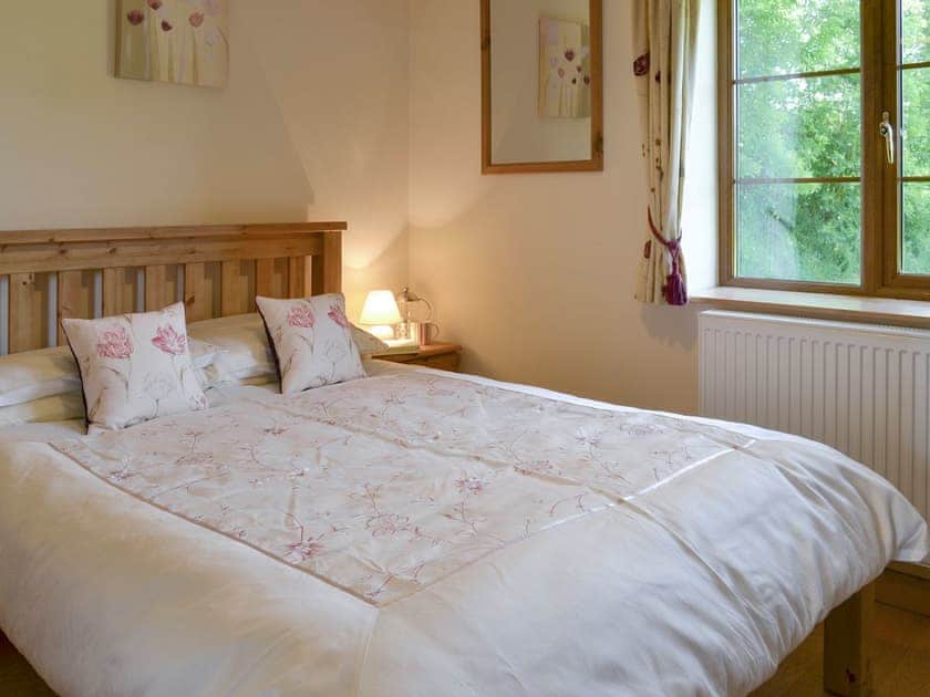 Relaxing double bedroom | Tarka’s Holt Log Cabin - Stowford Lodge Holiday Cottages, Langtree, near Great Torrington