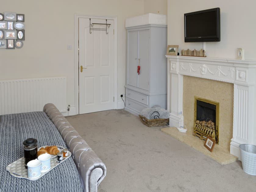 Spacious bedroom with super kingsized bed and feature fireplace | Naters Apartment, Whitley Bay, near Cullercoats