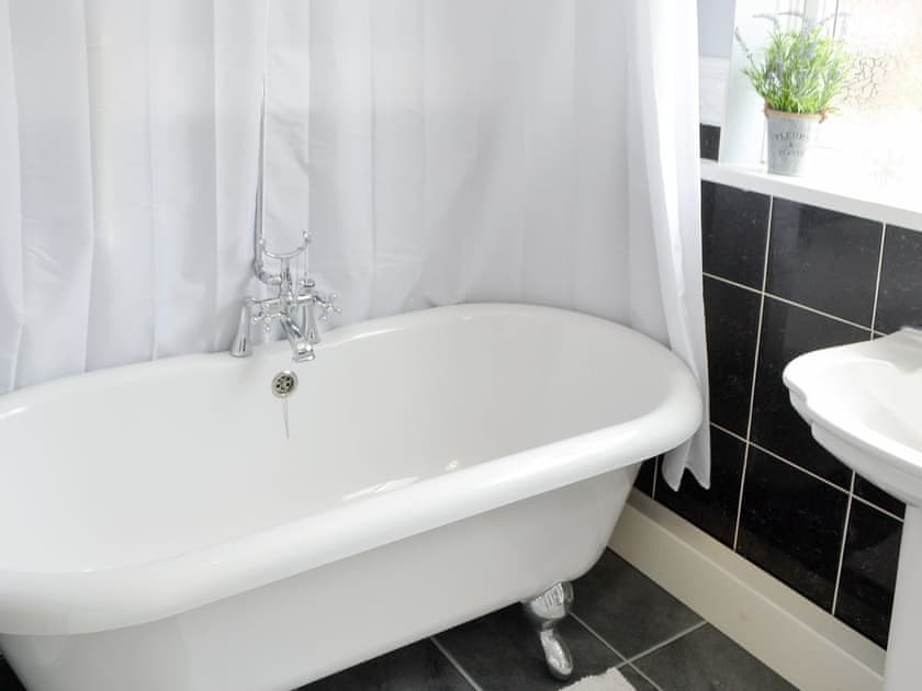 Freestanding roll-top bath with shower above | Naters Apartment, Whitley Bay, near Cullercoats