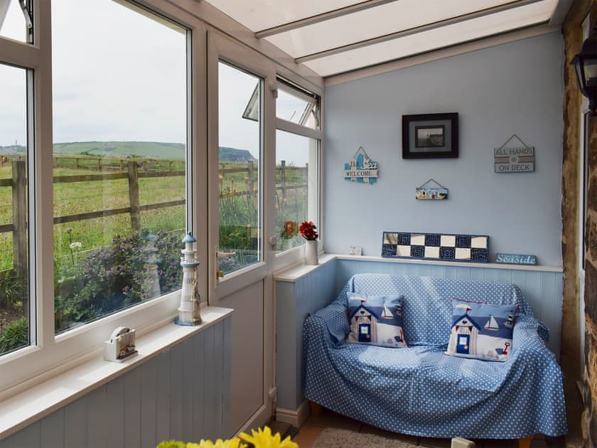 Conservatory and dining room | Sea Breeze Cottage, Cowbar, near Staithes