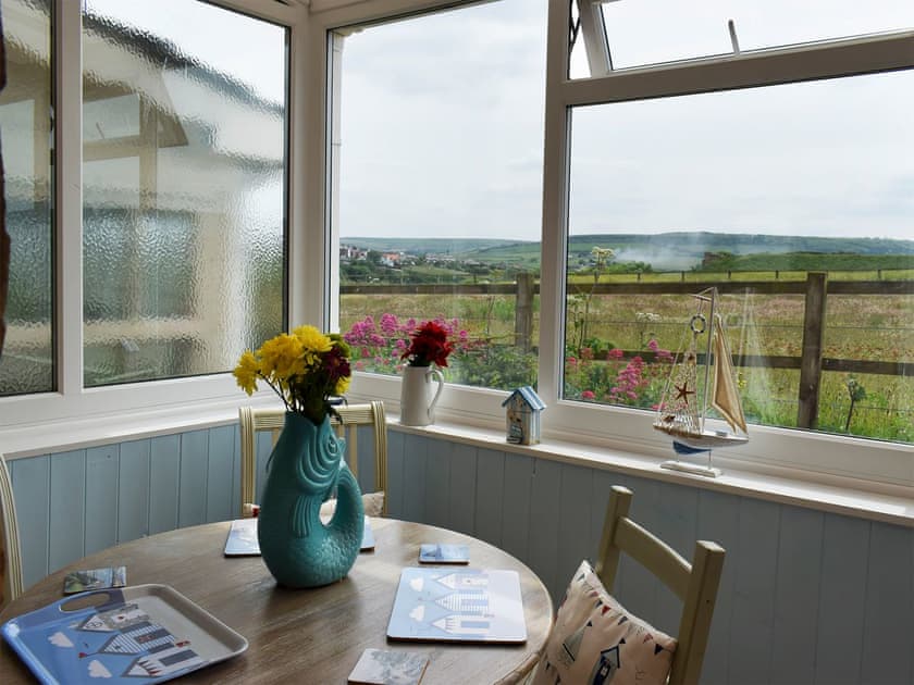 Conservatory and dining room | Sea Breeze Cottage, Cowbar, near Staithes