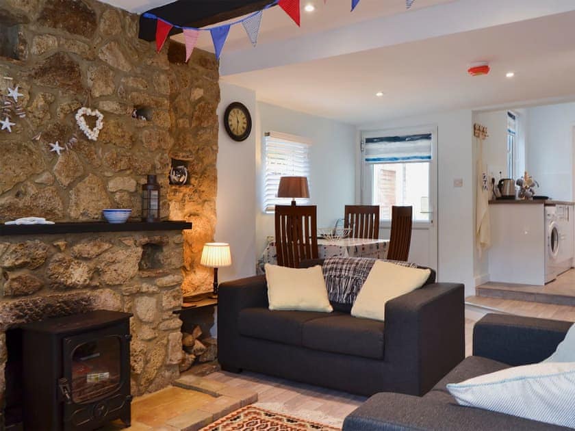 Living and dining area with wood burner | Horseshoe Cottage, Porchfield, near Cowes
