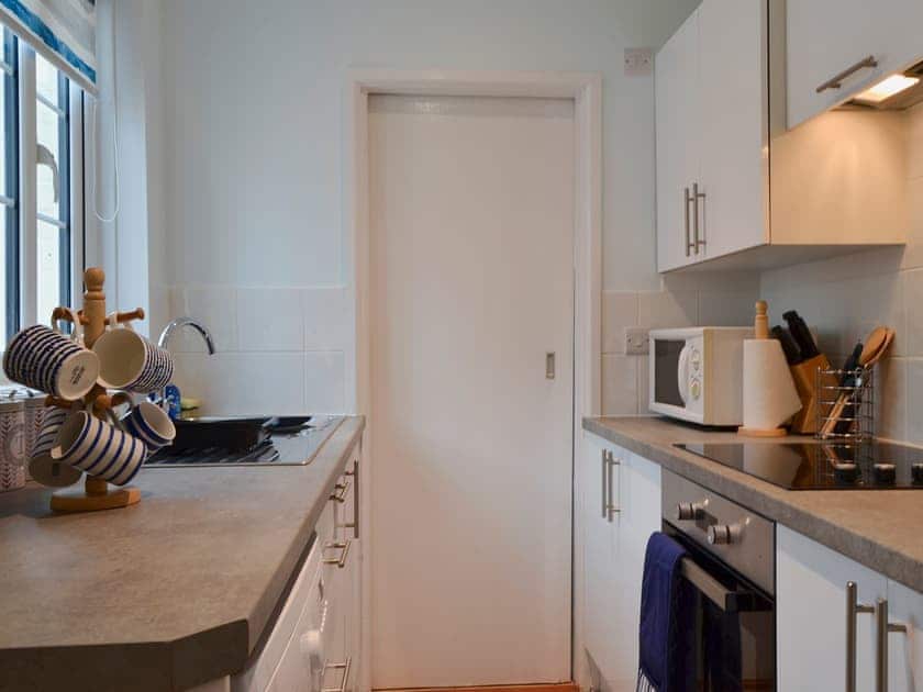 Galley style kitchen | Horseshoe Cottage, Porchfield, near Cowes