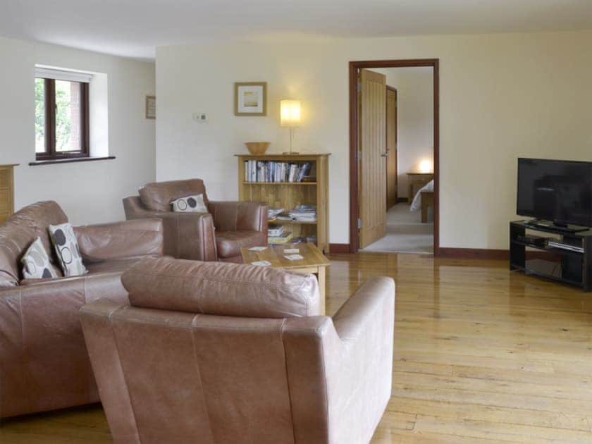 Spacious open-plan living space with wooden floor | Millers Rest - Burracott Farm, Poundstock, Bude