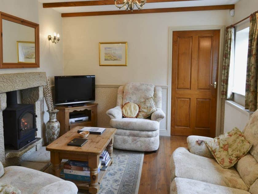 Cosy living area with gas fire and beams | Swallowtail Cottage - Studley House Farm Cottages, Ebberston, near Scarborough