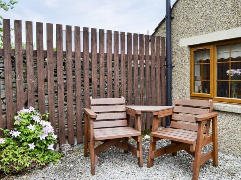 Small courtyard with sitting-out area and garden furniture | Swallowtail Cottage - Studley House Farm Cottages, Ebberston, near Scarborough