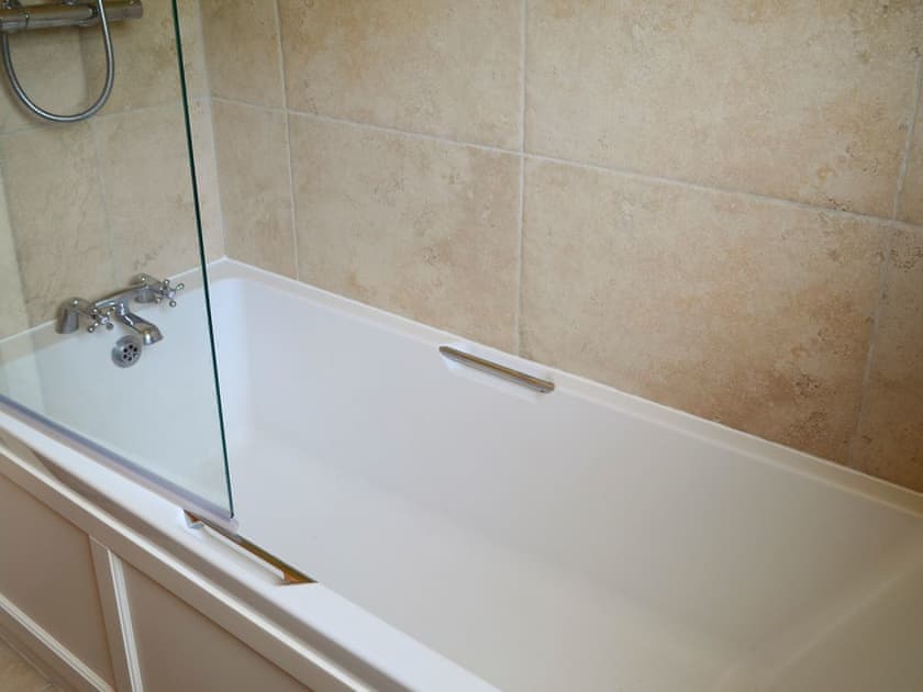 Shower over bath within family bathroom | Oakdene Lodge, Wimborne