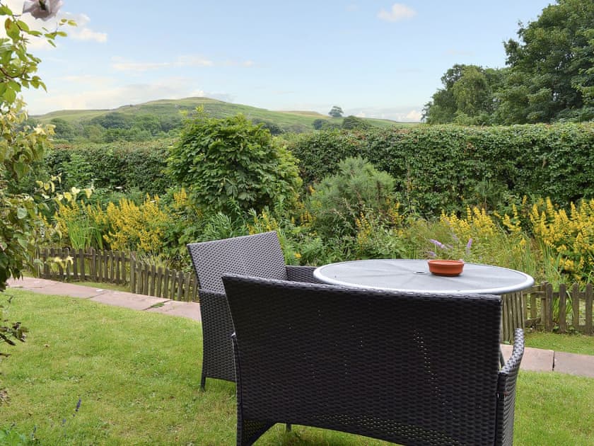 Sit out in the lovely garden and admire the view | Station Master’s House - Torver Station Cottages, Torver, near Coniston