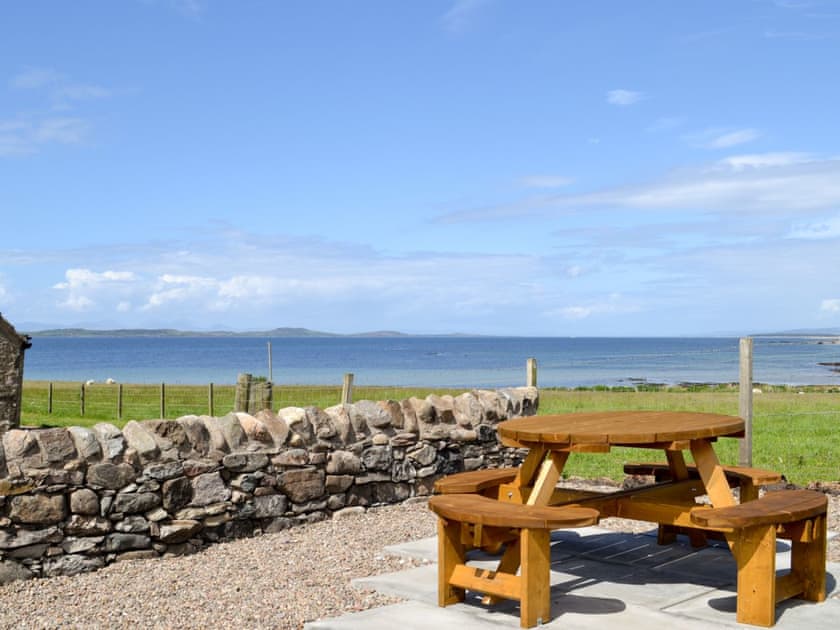 Outdoor seating area with fantastic views | Charlie’s Cottage, Muasdale, near Campbeltown