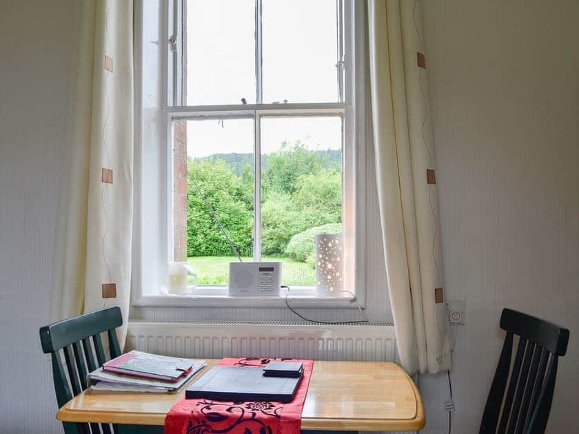 Compact dining area with wonderful view over the garden to the fells beyond | Ticket Office - Torver Station Cottages, Torver, near Coniston