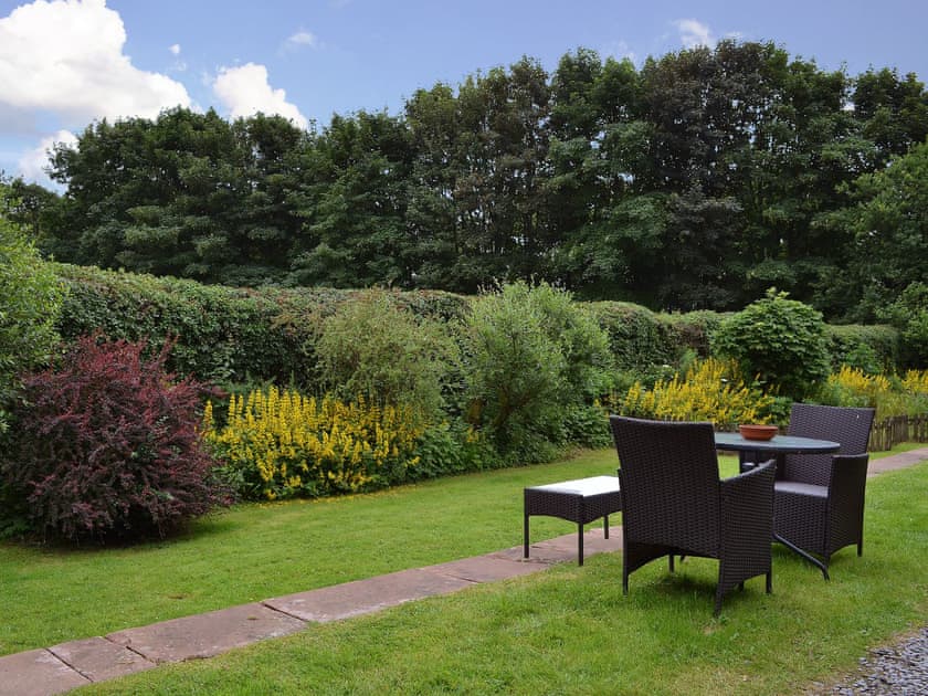 Leafy garden with lovely sitting out area | Ticket Office - Torver Station Cottages, Torver, near Coniston