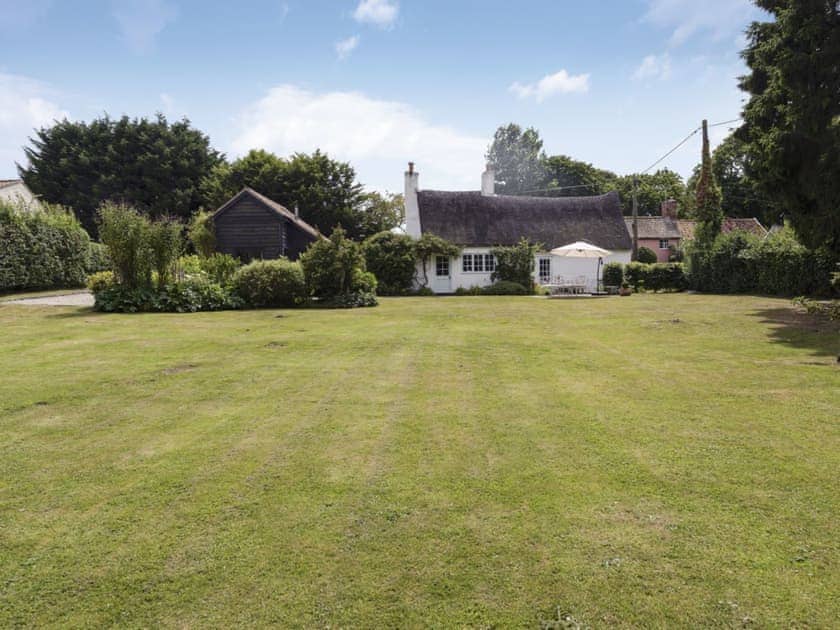 Enclosed lawned garden with patio and garden furniture | Thatched Cottage, Sternfield, near Aldeburgh