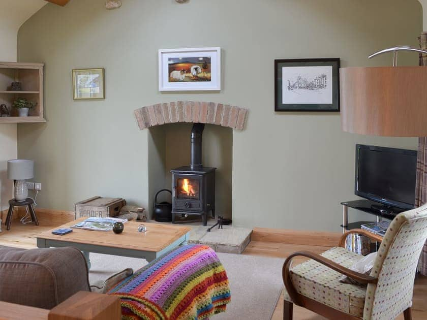 Living area with cosy wood burner | Brow View Cottage, Ravenstonedale, near Kirkby Stephen