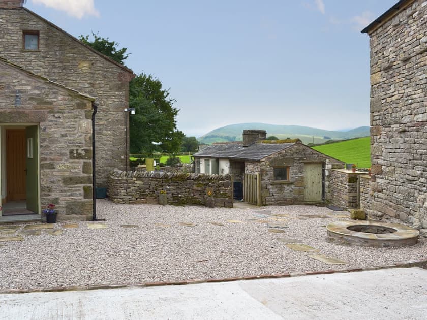 Gravelled courtyard with covered well | Brow View Cottage, Ravenstonedale, near Kirkby Stephen