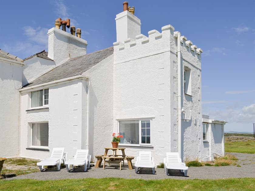 Impressive façade and outdoor seating area | Bwthyn Y Borth, Rhoscolyn, near Holyhead