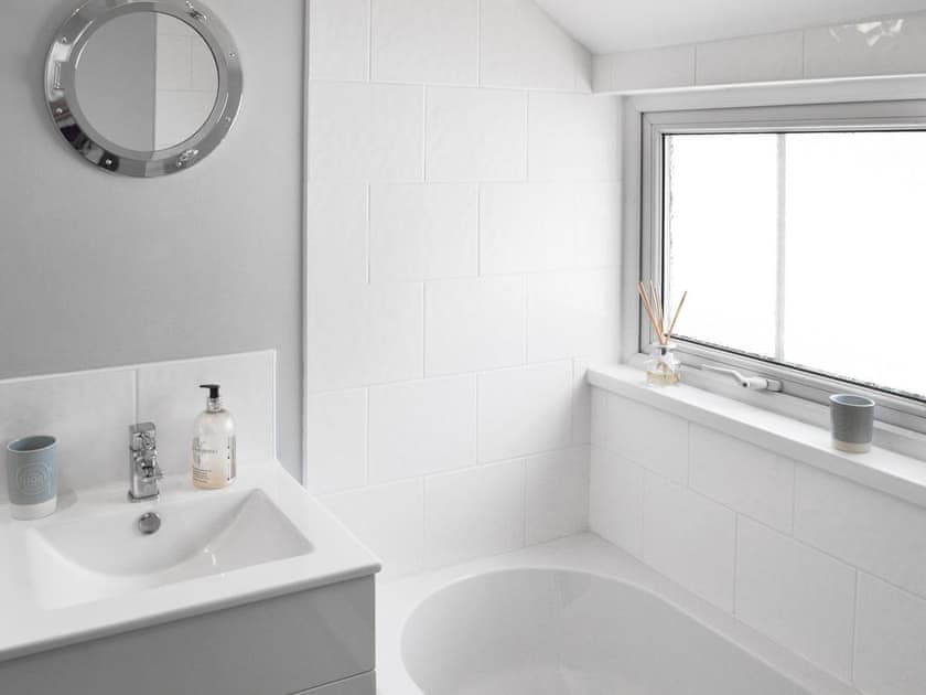 Bathroom with shower over bath, and toilet | Morvoren (Sea Maiden) Cottage, The Lizard Village, near Helston