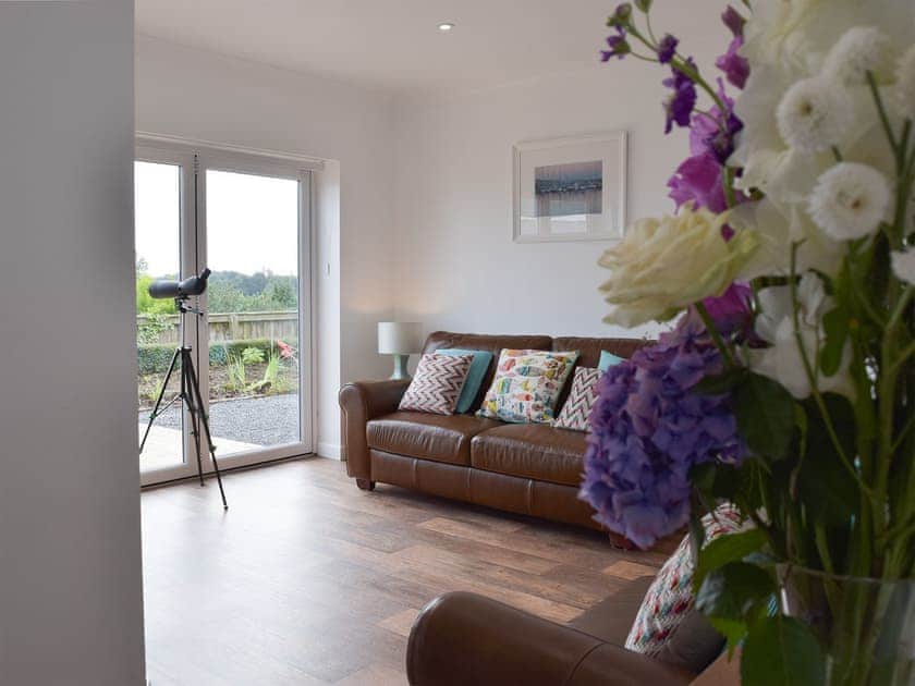 Open plan living space with wood burner | Caldey View, Near Stepaside, Saundersfoot