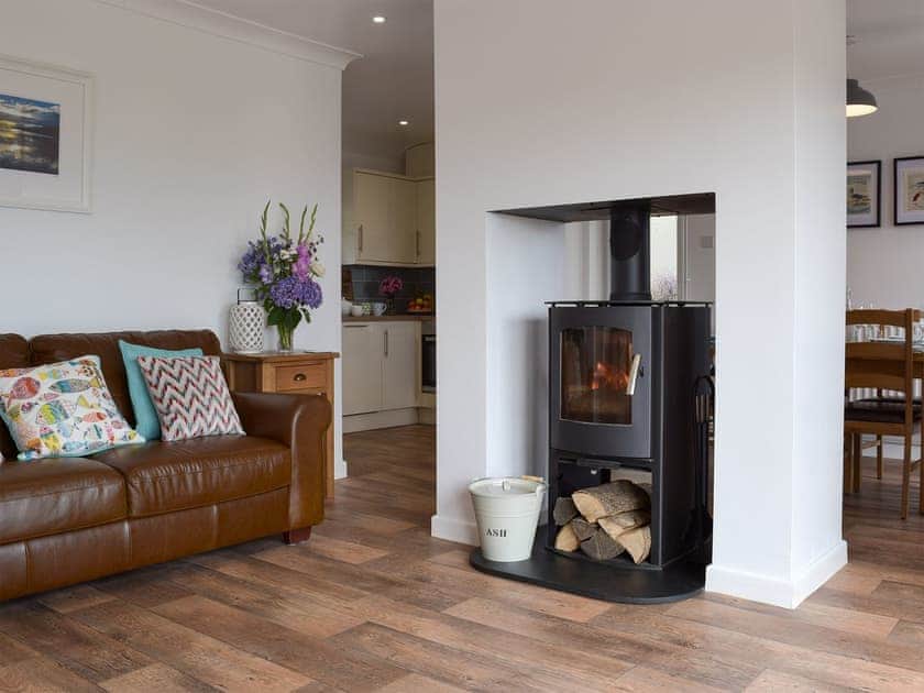 Open plan living space with wood burner | Caldey View, Near Stepaside, Saundersfoot