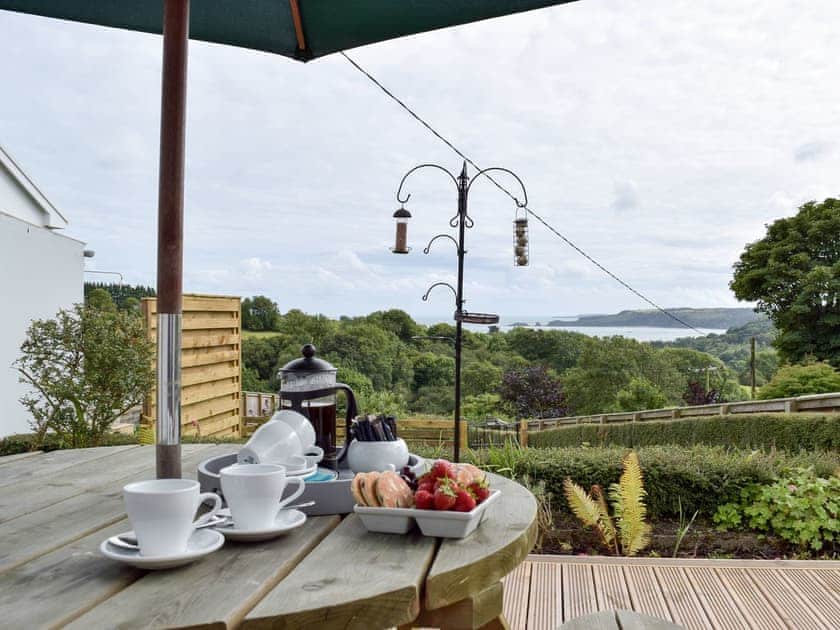 Outdoor dining area with views | Caldey View, Near Stepaside, Saundersfoot