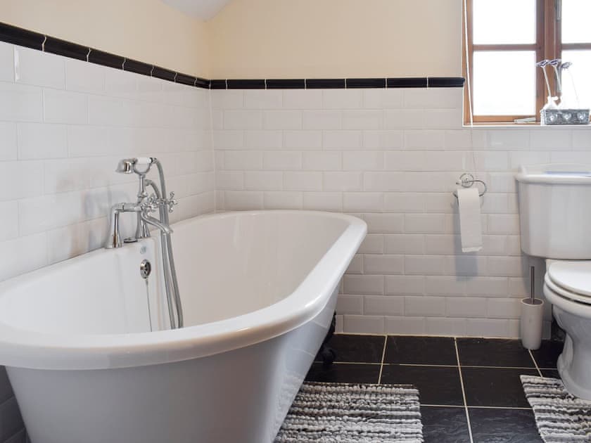Family bathroom with roll-top bath | Bryncrwn Cottage, Llanfarian, Aberystwyth