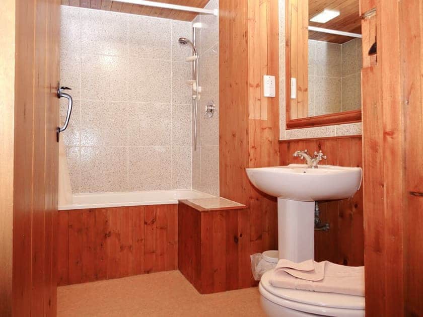 Bathroom with shower over bath, and toilet | Stable Barn, Mungrisdale, near Keswick