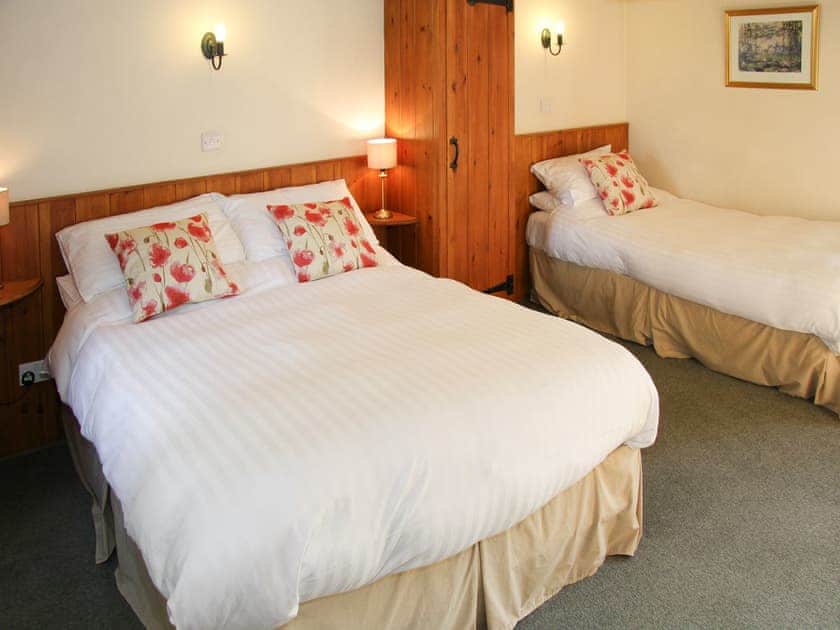 Relaxing bedroom with double bed and single bed | Stable Barn, Mungrisdale, near Keswick