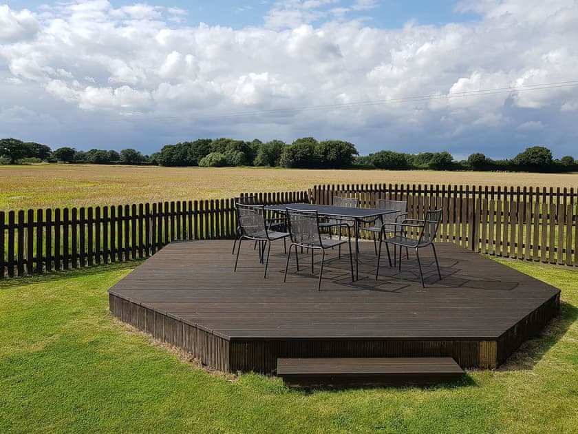 Raised decked area with open views over the countryside | Summer House Stables, Catfield, near Stalham