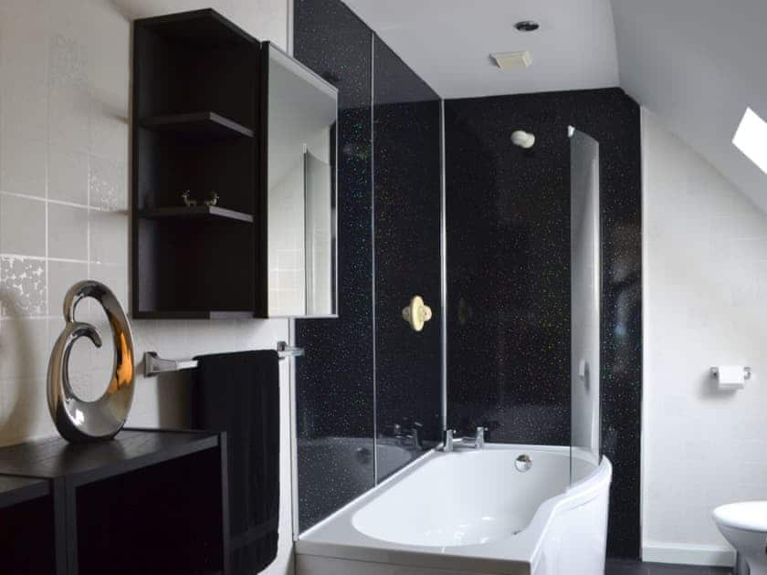 Bathroom with shower over bath and heated towel rail | River Mill House, Ballachulish, near Fort William