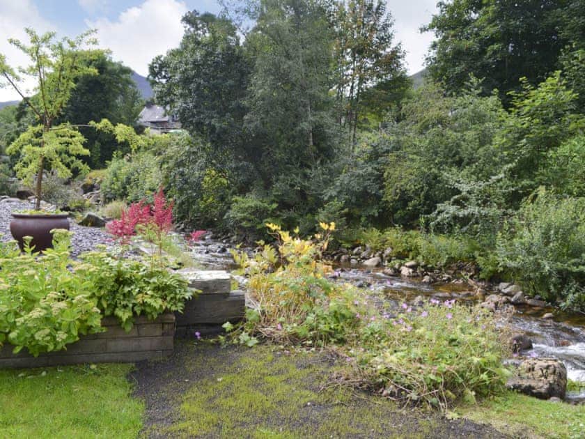 A delightful stream gently flows alongside the garden | River Mill House, Ballachulish, near Fort William