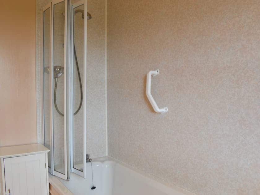 Bathroom with shower over bath and heated towel rail | Gullieside Cottage, Kirkandrews, near Kirkcudbright