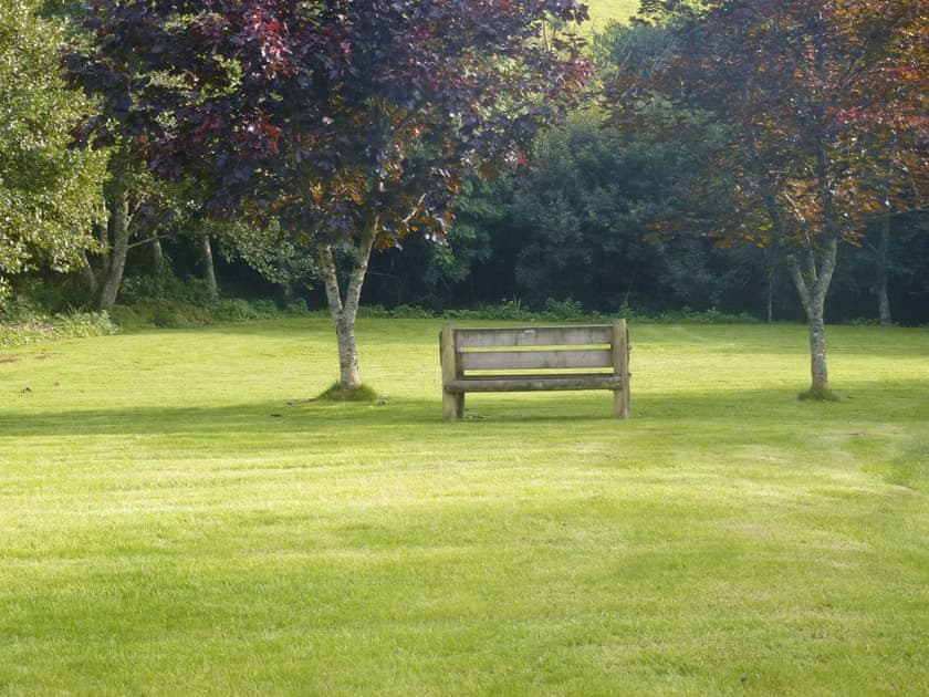 Seating area within garden | Camellia Cottage - Kilbol Country Cottages, Polmassick, near St Austell