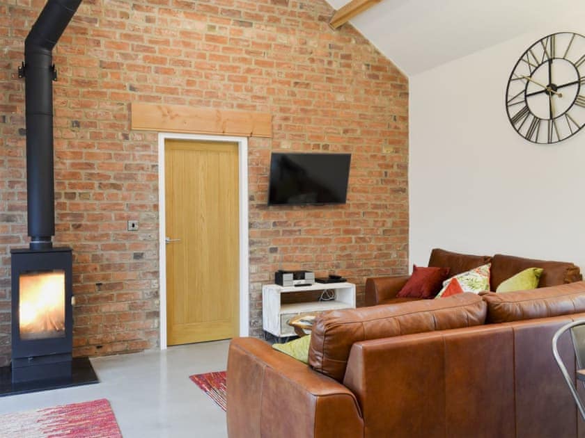 Bright and cosy living area with wood burener | Bluebell Barn, Dunnington, near York