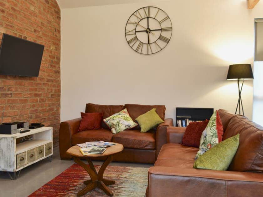 Bright and cosy living area with wood burener | Bluebell Barn, Dunnington, near York