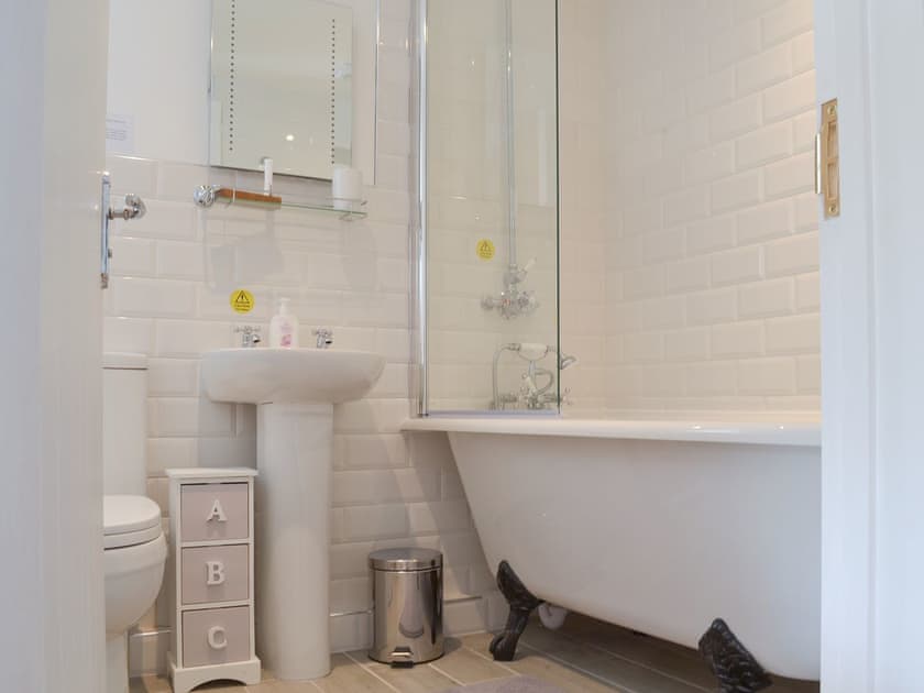 Stylish bathroom with roll top bath and shower over | Bluebell Cottage, Over Stowey, near Taunton