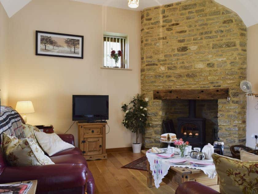 Beamed living room with wood-burning stove | Alfie&rsquo;s Barn, Ambrosden