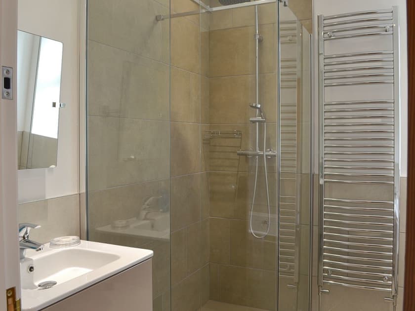 Bathroom with bath, shower cubicle and heated towel rail | The Moorings, Grange-over-Sands