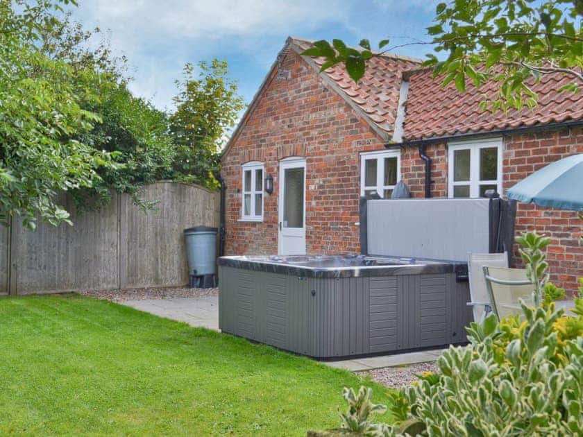 Relaxing and private hot tub on the patio | Clematis Cottage - Priory Garden Cottages, Anderby, near Chapel St Leonards