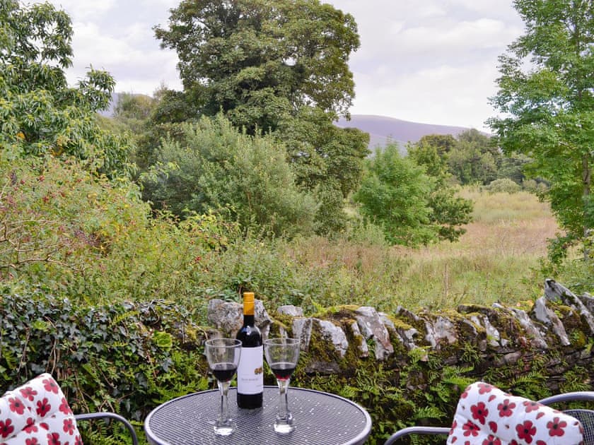 Lovely rural views from the outdoor seating area | Skelmorlie Cottage, Portinscale, near Keswick