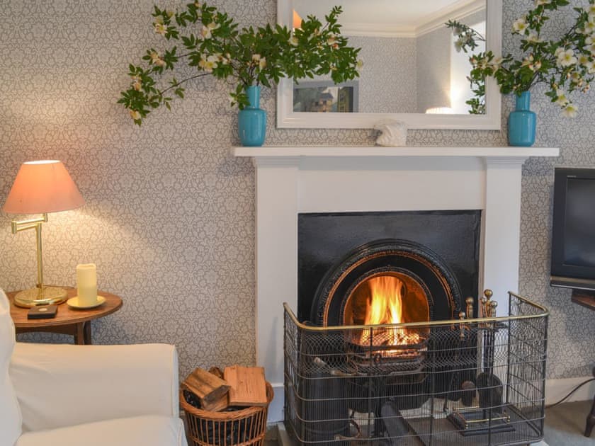 Warm and welcoming living room with open fireplace | Garden Cottage, Strachur, near Dunoon