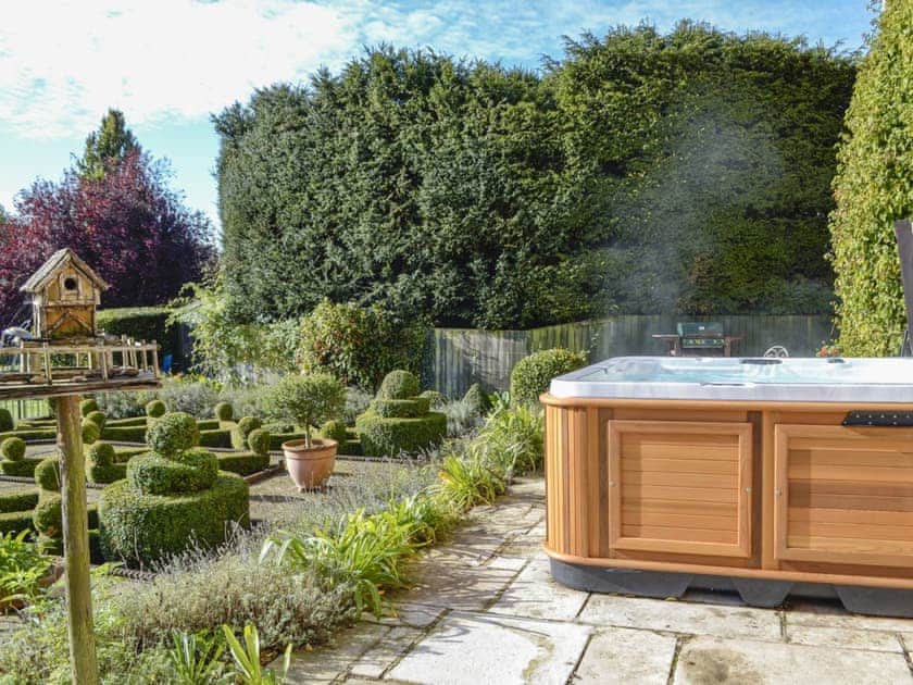Paved patio with hot-tub | Downwood Vineyard, Blandford