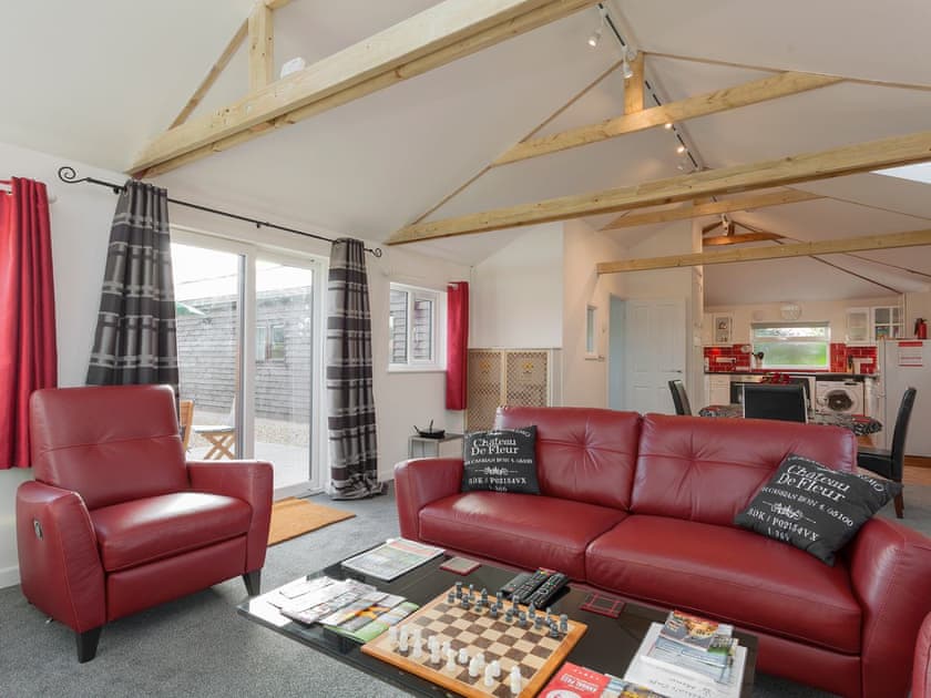 Comfortable lounge area with wood burner and Freeview TV | Swallows’ Nest, Wool, near Wareham