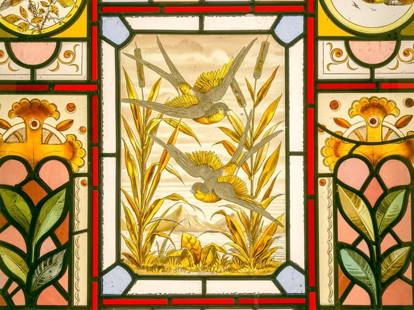 Detailed stained glass window in living room | Commons Farm Cottage, Wadsworth, near Hebden Bridge