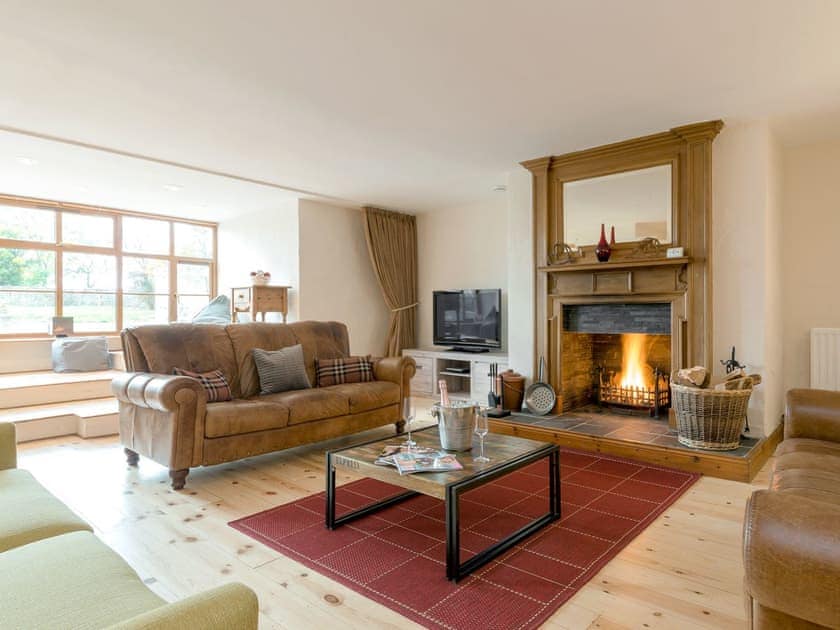Stunning living room with an open fire | The Old Mill - The Old Mill Cottages, Little Mill, near Craster