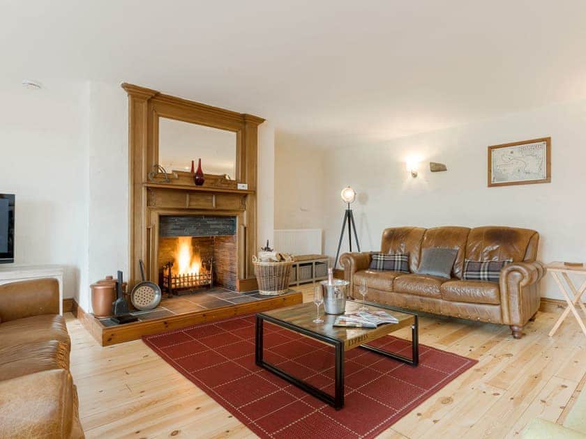 Warm and cosy living room with an open fire | The Old Mill - The Old Mill Cottages, Little Mill, near Craster